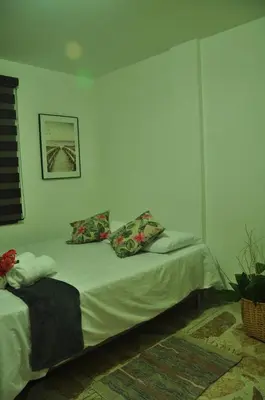 a bedroom with a bed with two pillows on it at live Medellín desde un Apartamento Céntrico y Cómodo in Medellín
