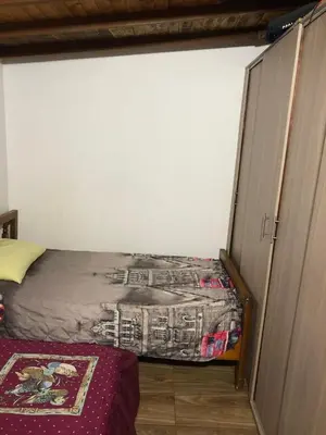a small bedroom with a bed and a closet at Villa Graciela in Horizonte
