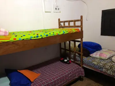 two bunk beds in a small room with a bed at Villa Graciela in Horizonte