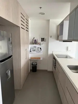 a white kitchen with a sink and a counter at PORTANOVA SUITES - Apartamento de lujo, muy cómodo, a tan sólo 5 minutos del aeropuerto JMC in Rionegro