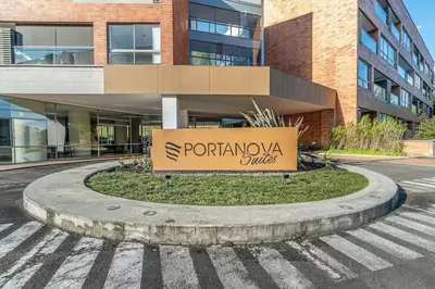 a sign on a street in front of a building at PORTANOVA SUITES - Apartamento de lujo, muy cómodo, a tan sólo 5 minutos del aeropuerto JMC in Rionegro
