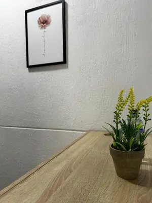 a plant sitting on a table next to a picture at Jireh alojamientos in Medellín