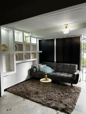 a living room with a couch and a table at Jireh alojamientos in Medellín