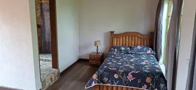a bedroom with a bed with a floral bedspread at Moss in San Isidro