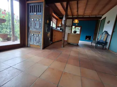 a kitchen with a large tile floor and an open door at Moss in San Isidro