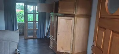 a large wooden cabinet in a room with a window at Moss in San Isidro