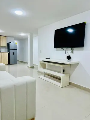 a living room with a flat screen tv on a wall at Apartamentos laureles estadio 101 ED MILA in Medellín