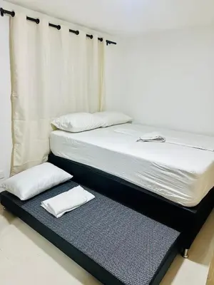 a bed with two white pillows on top of it at Apartamentos laureles estadio 101 ED MILA in Medellín