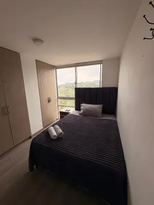 a bedroom with a bed with two shoes on it at Apartamento en Manizales in Manizales