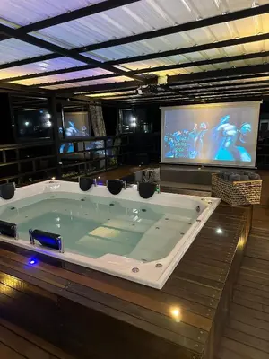 a large jacuzzi tub in a room with a tv at Villa Santa Luz in La Pradera