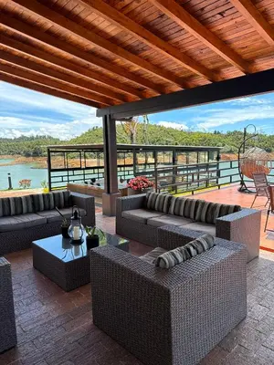 a patio with couches and tables on a deck at Villa Santa Luz in La Pradera