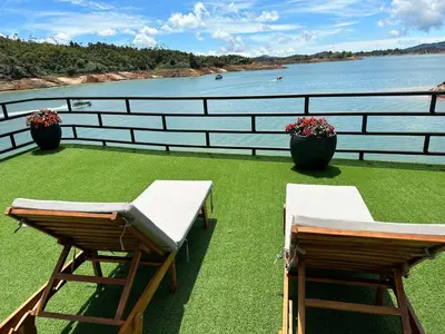 a balcony with two benches and a view of the water at Villa Santa Luz in La Pradera