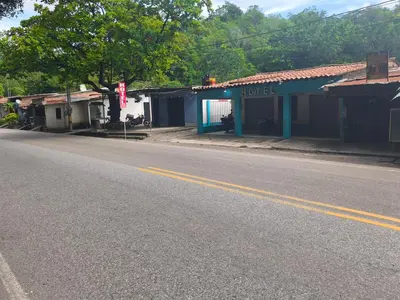 an empty street in a small town with hotel at hotel salome in Puerto Triunfo