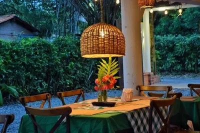 a table with a green table cloth and a lamp at Palma Serena Finca Hotel in Santa Fe de Antioquia