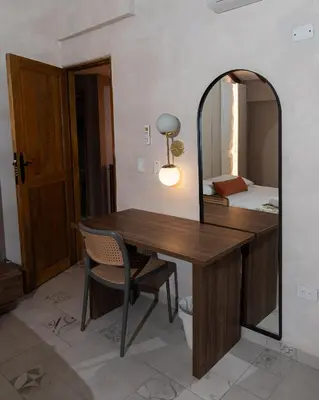 a room with a wooden table and a mirror at Palma Serena Finca Hotel in Santa Fe de Antioquia