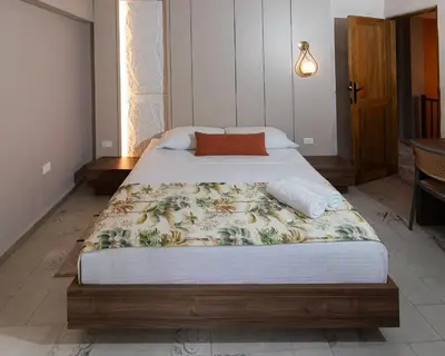 a bedroom with a large bed with at Palma Serena Finca Hotel in Santa Fe de Antioquia