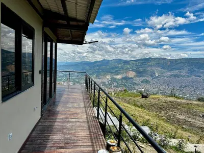 a balcony of a house with a view of the mountains at Finca Privada San Felix, Jacuzzi, Vistas Panoramicas Medellin
