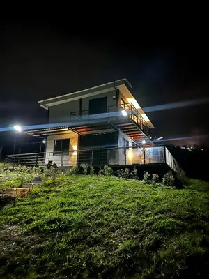 a house on top of a hill at night at Finca Privada San Felix, Jacuzzi, Vistas Panoramicas Medellin