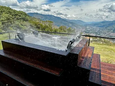 a hot tub with a fountain on top of a mountain at Finca Privada San Felix, Jacuzzi, Vistas Panoramicas Medellin