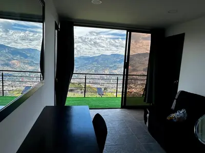 a dining room with a table and a view of the mountains at Finca Privada San Felix, Jacuzzi, Vistas Panoramicas Medellin