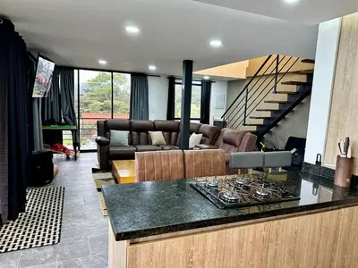 a living room with a couch and a table at Finca Privada San Felix, Jacuzzi, Vistas Panoramicas Medellin