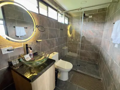a bathroom with a sink and a toilet and a shower at Finca Privada San Felix, Jacuzzi, Vistas Panoramicas Medellin