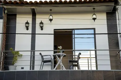 a balcony with two chairs and a table at Apartment suite Encanto de Caldas in Ruiosucio