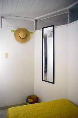 a bedroom with a bed and a hat on the wall at La 47 House - Family House in Manizales in Manizales