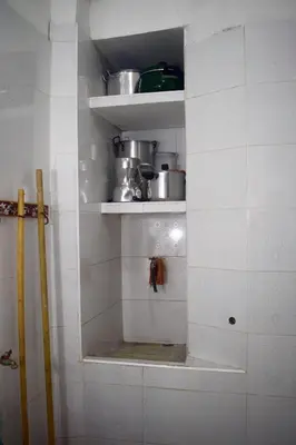 a kitchen with white walls and shelves with pots and pans at La 47 House - Family House in Manizales in Manizales