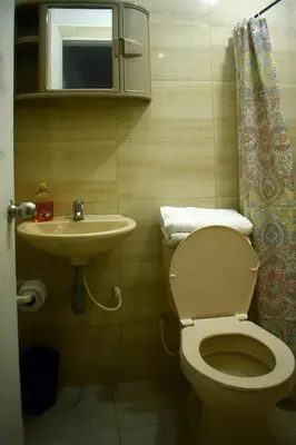 a small bathroom with a toilet and a sink at La 47 House - Family House in Manizales in Manizales