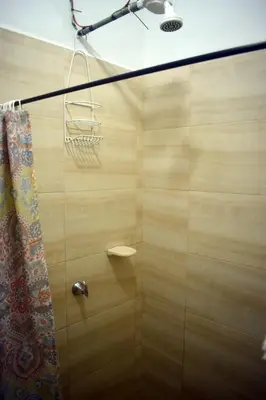 a bathroom with a shower with a shower curtain at La 47 House - Family House in Manizales in Manizales