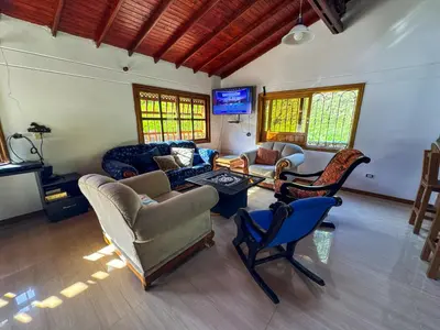 a living room with couches and chairs and a tv at Casa Finca Villa Laura 158 in Rionegro