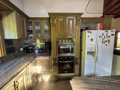 a kitchen with wooden cabinets and a white refrigerator at Casa Finca Villa Laura 158 in Rionegro