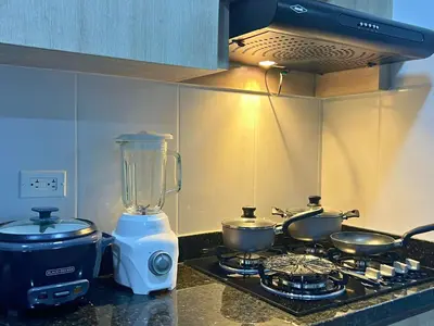 a kitchen counter with a blender and two pots on a stove at Apartamento Familiar en Sabaneta cerca al parque in Sabaneta