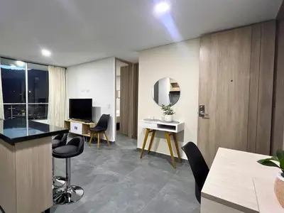 a living room with a desk and chairs and a mirror at Apartamento Familiar en Sabaneta cerca al parque in Sabaneta