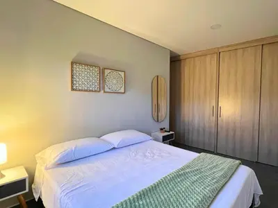 a bedroom with a large white bed with two pillows at Apartamento Familiar en Sabaneta cerca al parque in Sabaneta