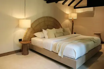 a bedroom with a large bed with white sheets and pillows at Isla Clara Hotel in San Francisco