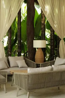 a living room with white furniture and trees at Isla Clara Hotel in San Francisco