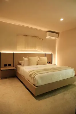 a bedroom with a large bed with white sheets and pillows at Isla Clara Hotel in San Francisco