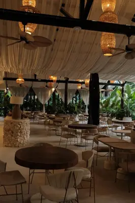 a dining room with tables and chairs and lights at Isla Clara Hotel in San Francisco