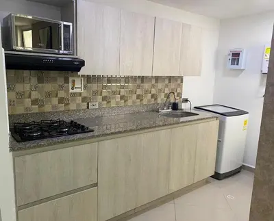 a kitchen with a sink and a stove and a refrigerator at 901-Apartamento Central Parque de Sabaneta in Sabaneta