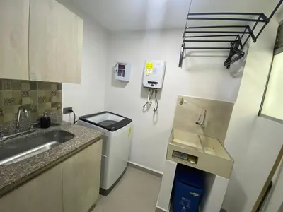 a small kitchen with a sink and a refrigerator at 901-Apartamento Central Parque de Sabaneta in Sabaneta