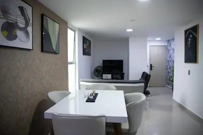 a living room with a white table and chairs at 901-Apartamento Central Parque de Sabaneta in Sabaneta