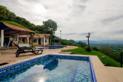 a swimming pool with a view of a house at Altos de Balaguer in Magallenes