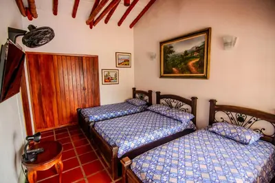 a bedroom with two beds and a table at Altos de Balaguer in Magallenes
