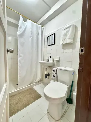 a bathroom with a toilet and a sink and a shower at CASA JAGUAR 4 Habitaciones, 4 Baños in Medellín
