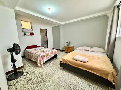 a bedroom with two beds and a camera in it at CASA JAGUAR 4 Habitaciones, 4 Baños in Medellín