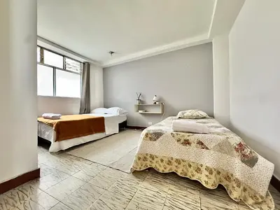 a bedroom with two beds and a window at CASA JAGUAR 4 Habitaciones, 4 Baños in Medellín