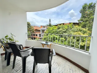 a balcony with chairs and a view of trees at CASA JAGUAR 4 Habitaciones, 4 Baños in Medellín