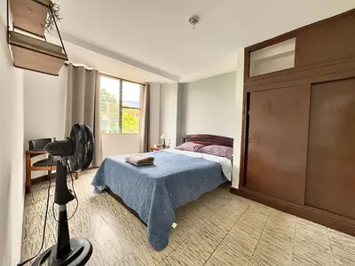 a bedroom with a bed and a large window at CASA JAGUAR 4 Habitaciones, 4 Baños in Medellín